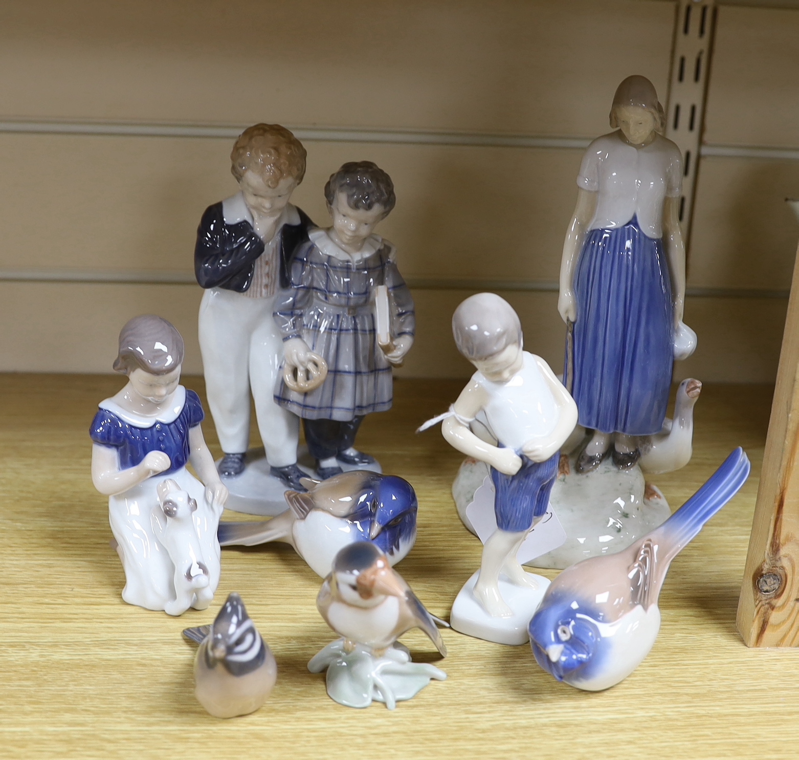 Eight items of mixed Royal Copenhagen and Bing & Grondahl, including figure groups birds and children, tallest 24cms high